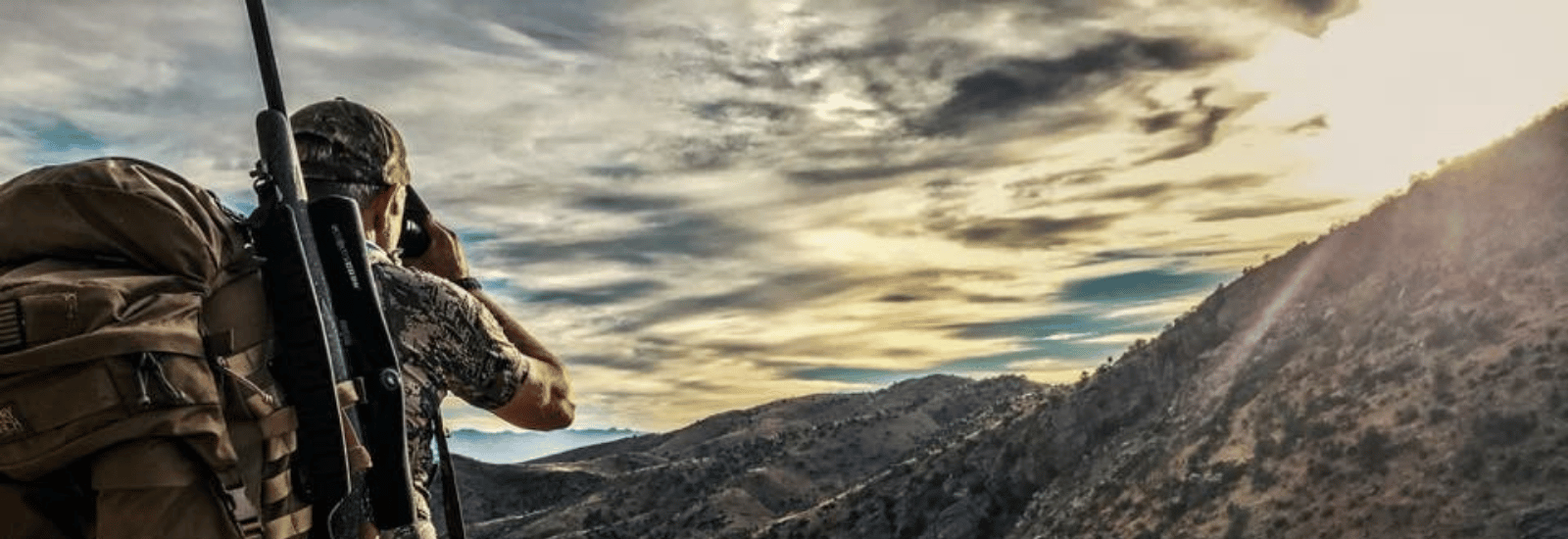 A man looking off a hill while hunting using GPO USA gear