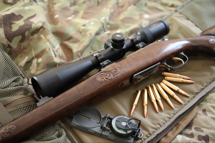 Picture of GPO Scope on top of Rifle with Camo background